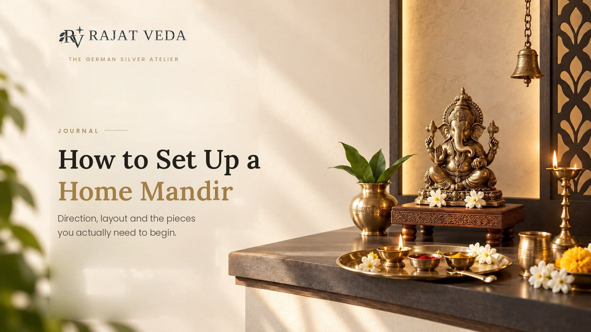 Home mandir shelf set up with a Ganesha idol on a carved chowki, a kalash of leaves, and a pooja thali holding a lit diya, kumkum and haldi