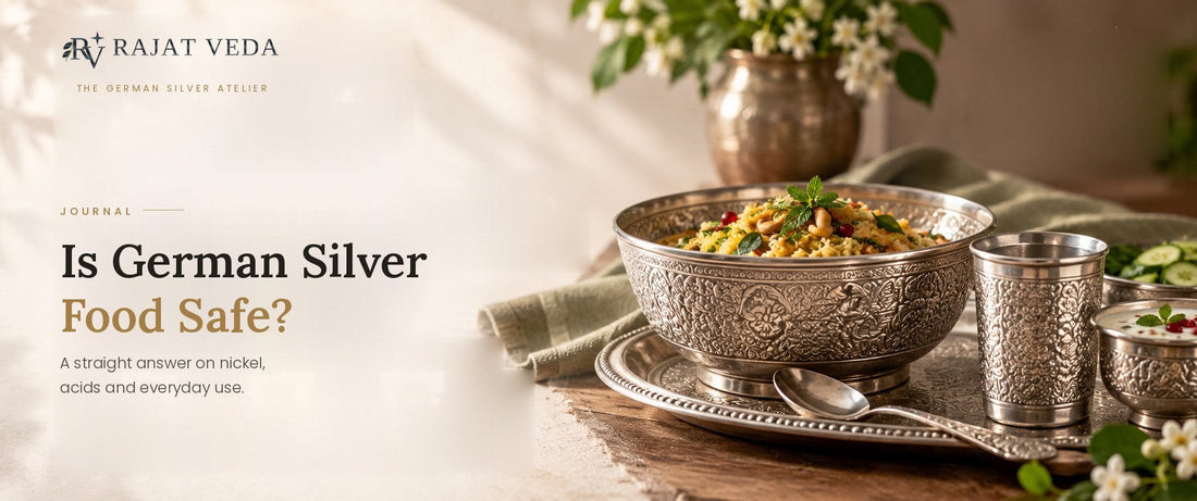 An engraved German Silver bowl of pulao served with a matching tumbler and plate on a wooden table