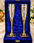 Pair of German Silver engraved goblets in a blue velvet gift box beside a lit diya