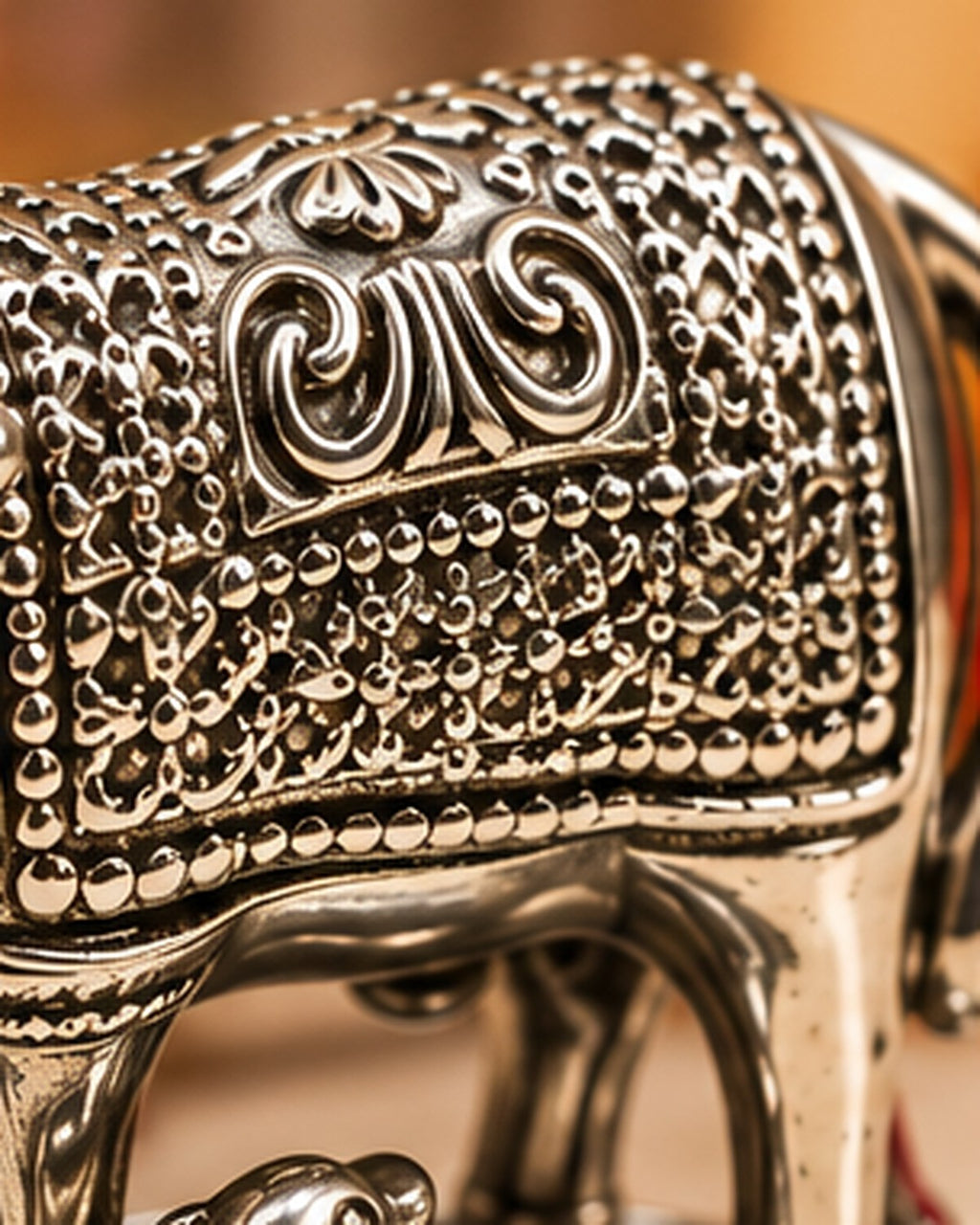 Hand-chased scroll and beaded dot work on the cow's saddle