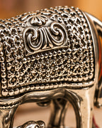 Hand-chased scroll and beaded dot work on the cow's saddle