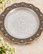 Six inch German Silver pooja plate with an embossed lotus centre and beaded rim
