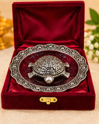 Kurma tortoise and plate packed in a red velvet gift box with a brass clasp