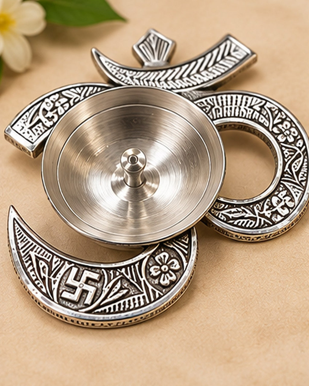 Om-shaped German Silver diya, the lamp well set inside the curve of the letter