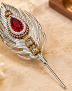 German Silver peacock feather sindoor pin resting on marble