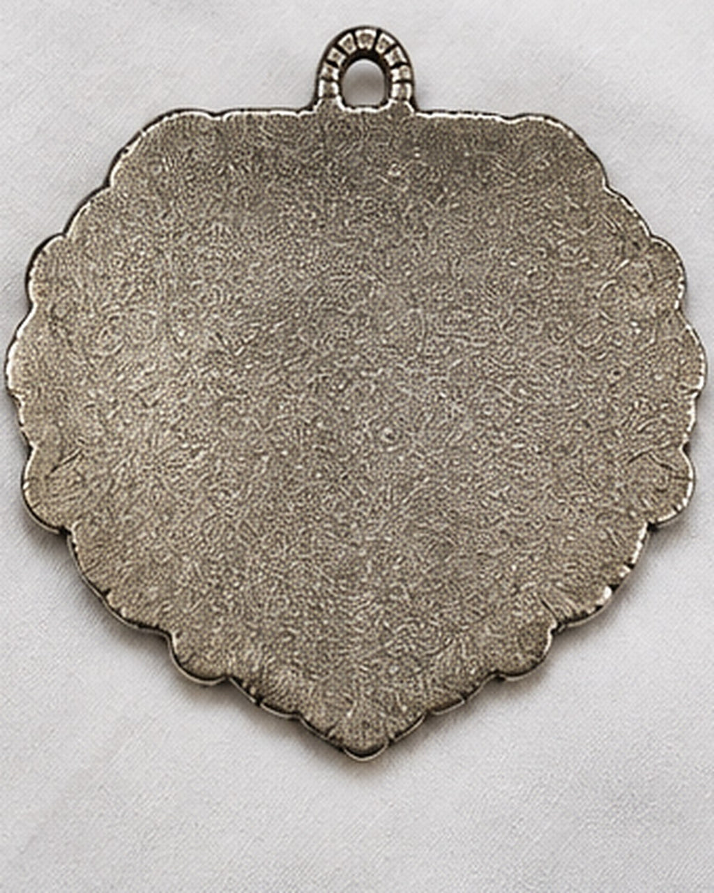 The plain unfinished back of the plaque, made to sit flat against a wall