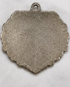 The plain unfinished back of the plaque, made to sit flat against a wall
