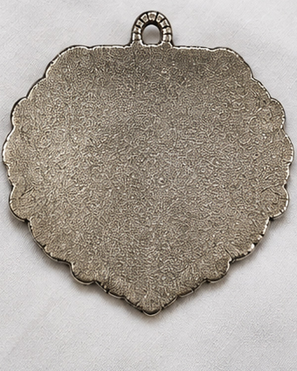 The plain unfinished back of the plaque, made to sit flat against a wall