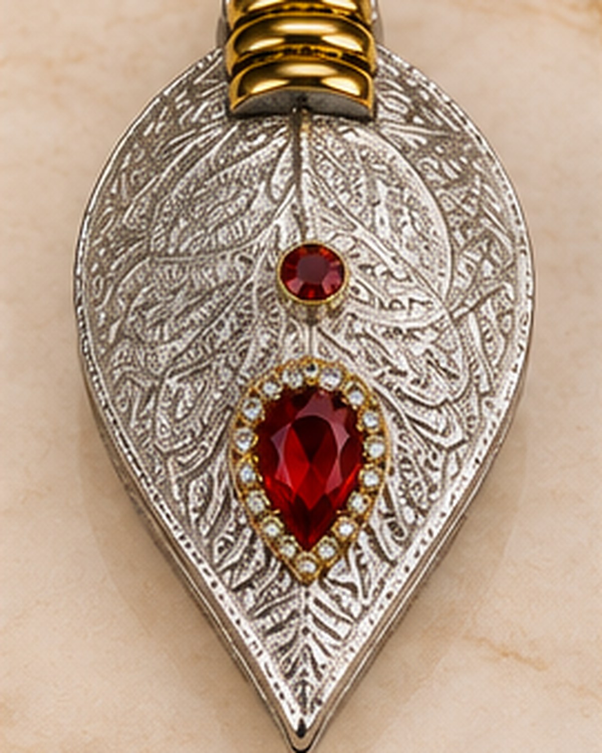 Paan-leaf sindoor daani closed, with red and clear set stones on the lid