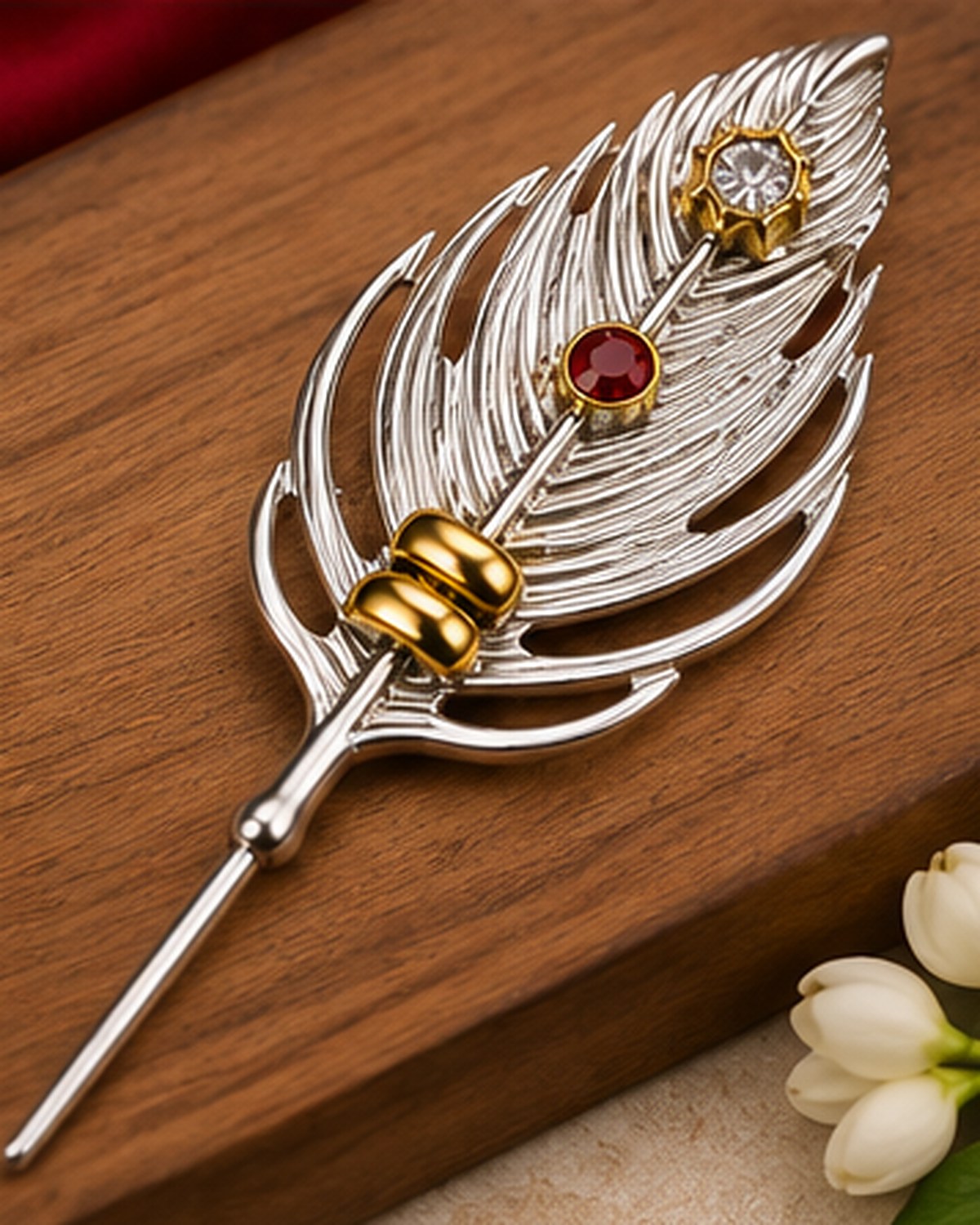 German Silver peacock feather sindoor pin resting on wood