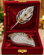 Sindoor daani and feather pin in a red velvet gift box beside a lit diya